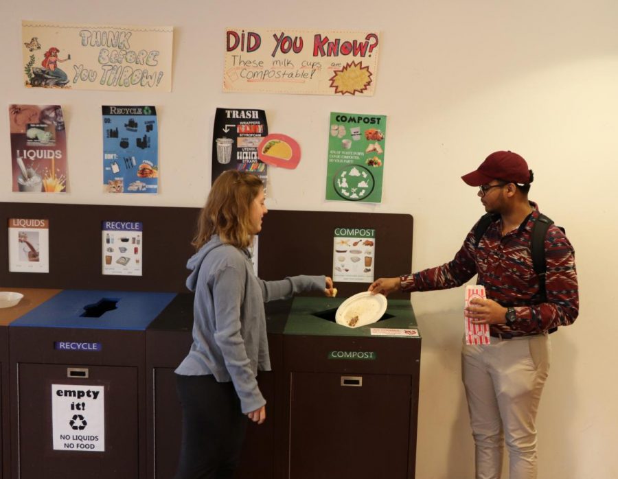 Pictured: Students using the compost bin in the Media Caf.