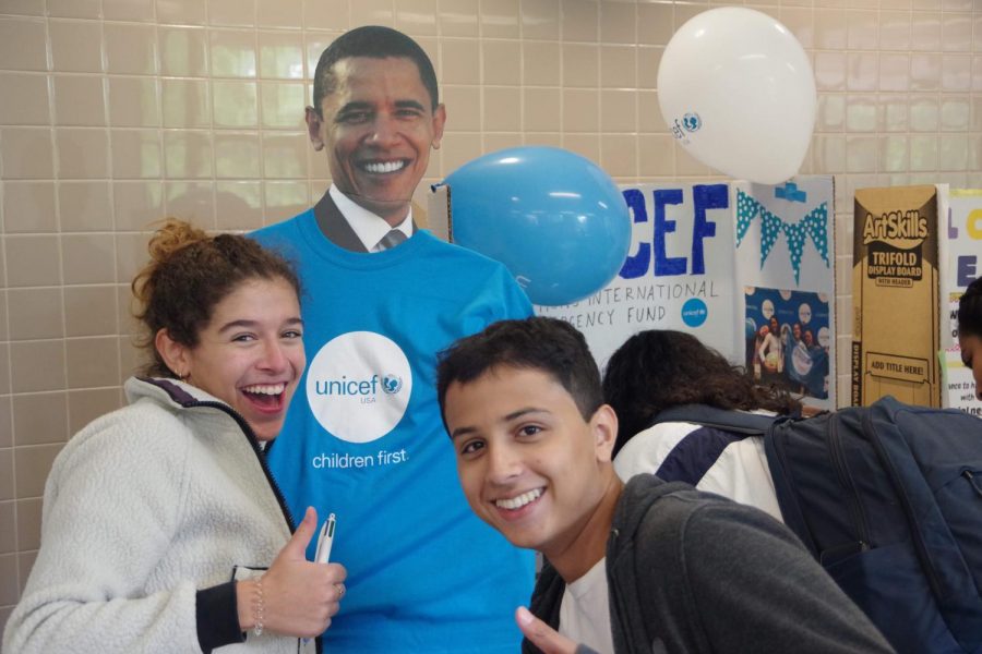 Pictured: Unicef members posing with a Barack Obama cutout.