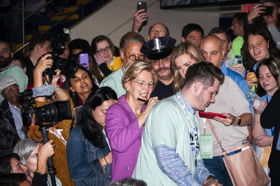 Pictured: Warren signs a supporter’s shirt at a convention in Springfield, Massachusetts.