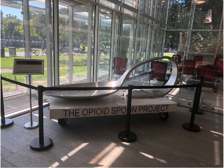 The bent spoon on display at the Cambridge Public Library's main branch.