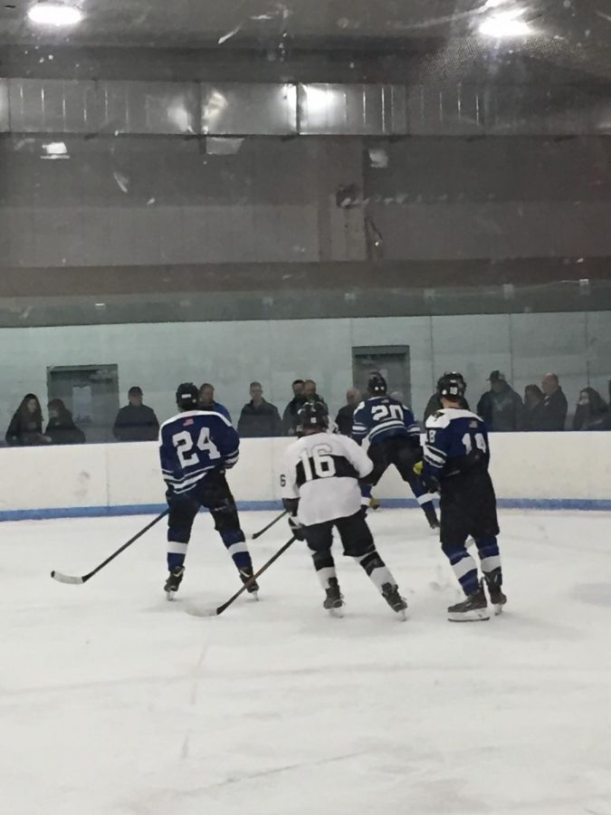 Pictured: The CRLS Varsity Boys Hockey team faces off against Bedford in a tough matchup.