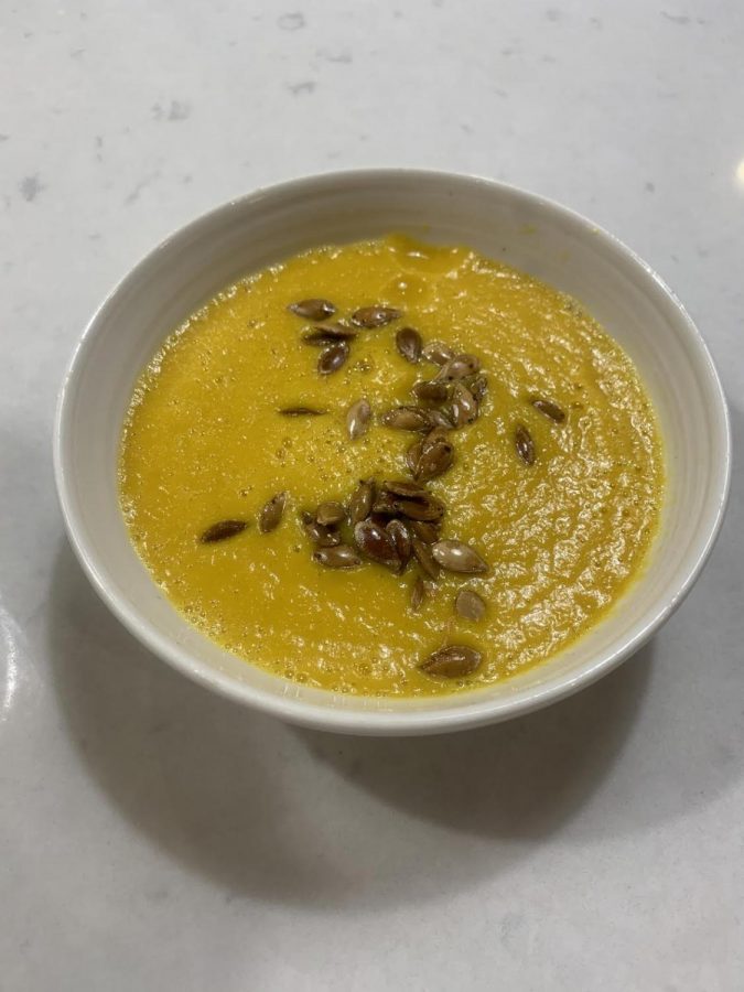 Butternut squash soup topped with roasted butternut squash seeds.